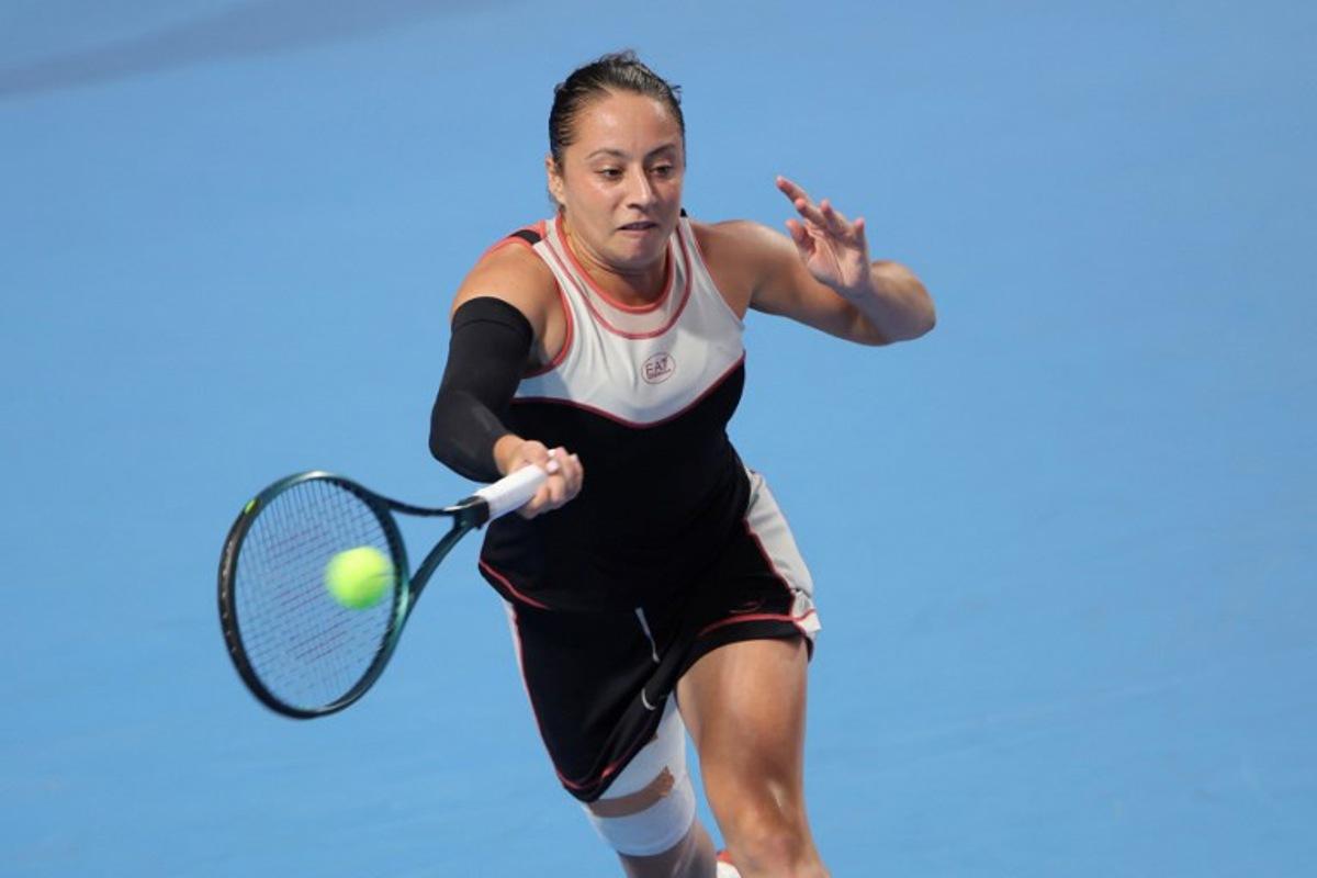 Italy's Elisabetta Cocciaretto hits a return to USA's Ann Li during their women's singles quarter-final match at the Guangzhou Open tennis tournament in Guangzhou, China's southern Guangdong province on October 24, 2025. -STR / AFP
