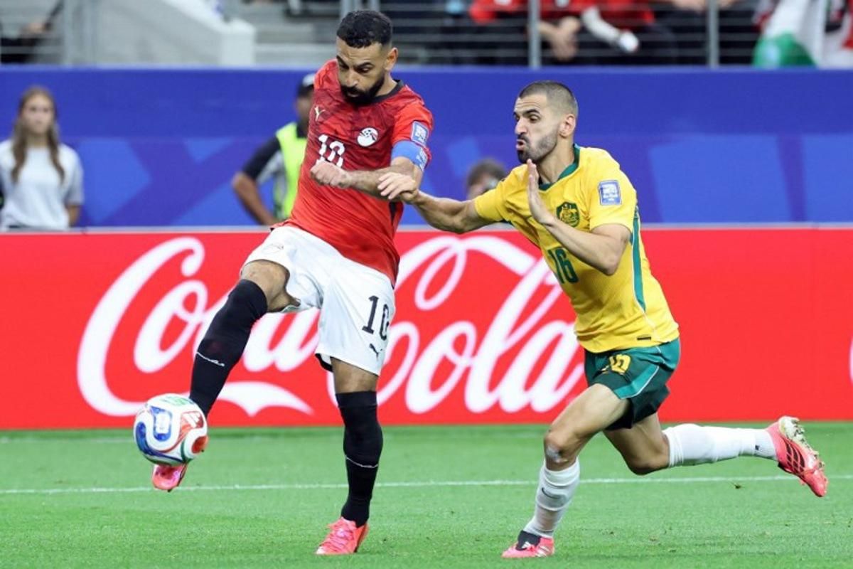 Egypt's forward #10 Mohamed Salah (L) fights for the ball with Australia's defender #16 Aziz Behich during the 2026 World Cup round of 32 football match between Australia and Egypt at the Dallas Stadium in Arlington on July 3, 2026. Thomas COEX / AFP