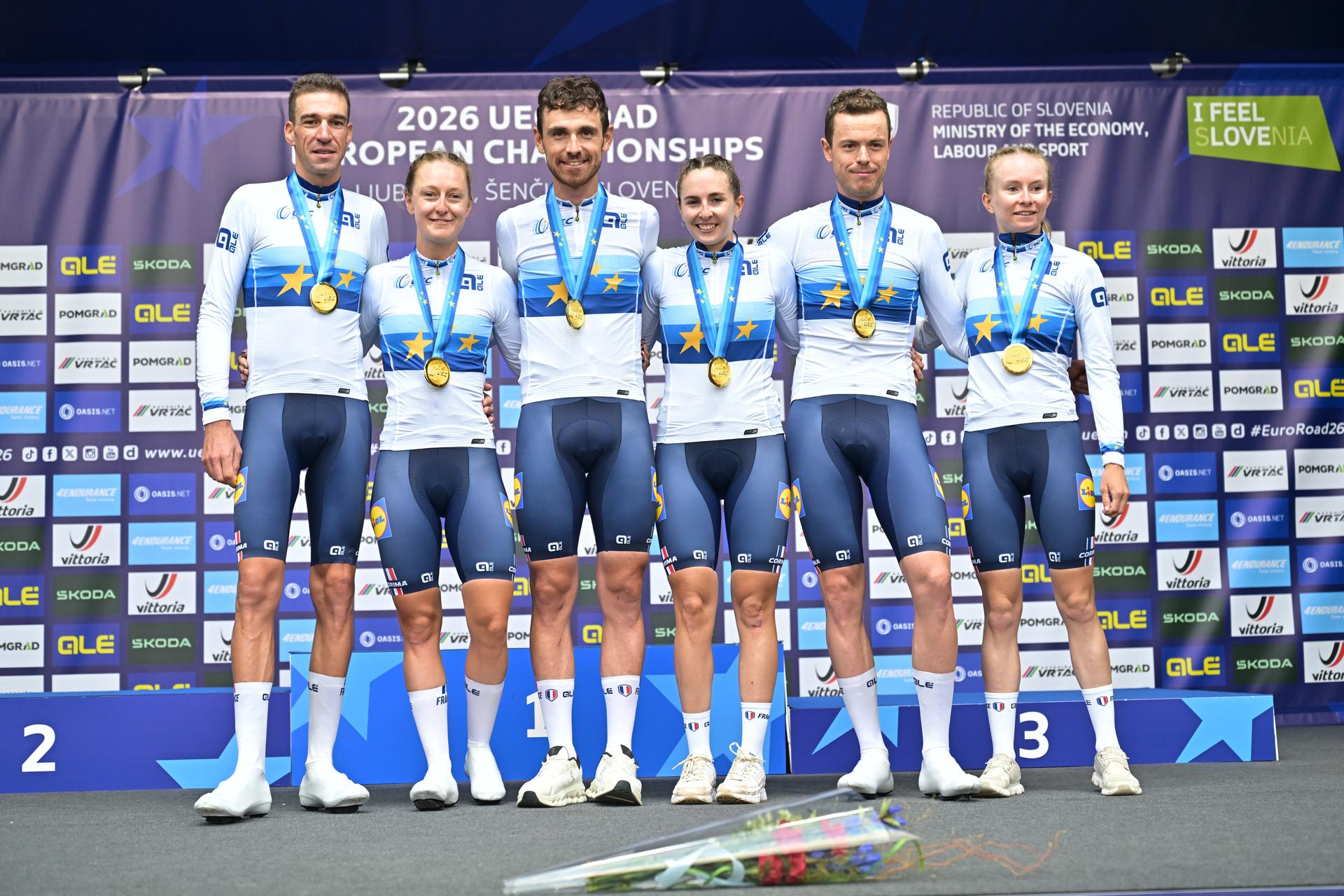 Team France celebrates on the podium after winning the time trial mixed relay elite race (44,2 km) at the cycling UEC Road European Championships, in Ljubljana, Slovenia Tuesday 6 October 2026. The UEC Road European Championships are taking place from 02 to 07 October in Ljubljana, Slovenia. BELGA PHOTO DAVID PINTENS