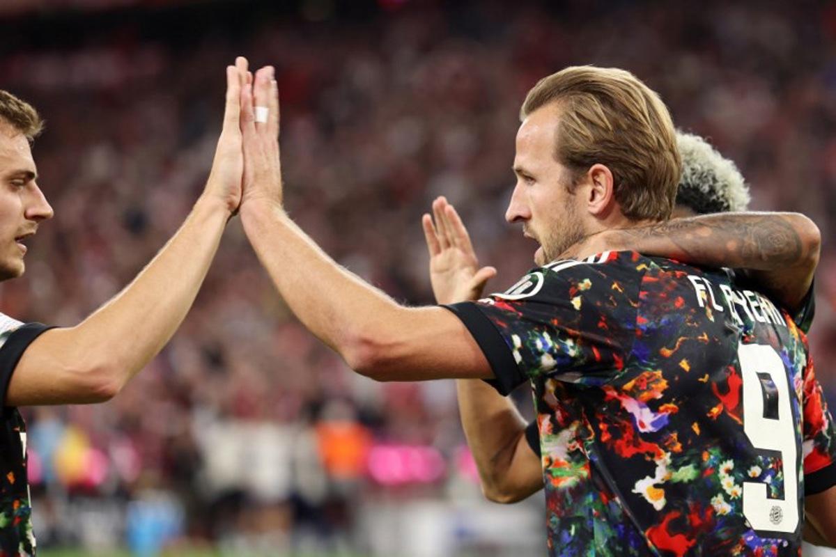 Bayern Munich's English forward #09 Harry Kane celebrates scoring his team's second goal with teammates during the German first division Bundesliga football match between FC Bayern Munich and Union Berlin in Munich, southern Germany on September 18, 2026. Alexandra BEIER / AFP