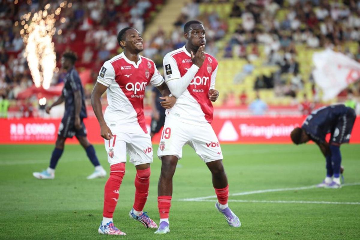 Monaco's French forward #19 George Ilenikhena (R) celebrates with Monaco's Belgian midfielder #17 Stanis Idumbo (L) after scoring Monaco's fifth goal during the French L1 football match between AS Monaco and FC Metz at the Louis II Stadium (Stade Louis II) in the Principality of Monaco, on September 21, 2025. Valery HACHE / AFP