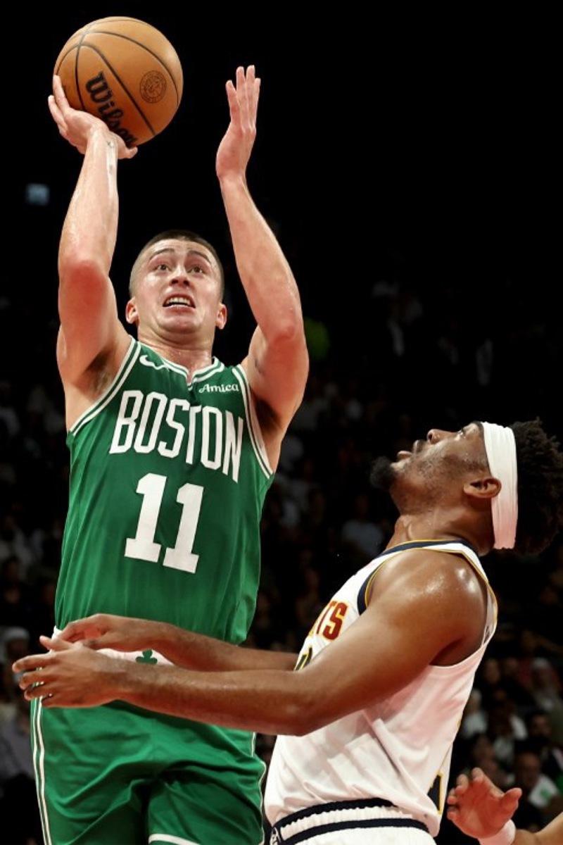 Boston Celtics' guard #11 Payton Pritchard jumps to shoot during the NBA Preseason game between the Boston Celtics and the Denver Nuggets at the Etihad Arena in Abu Dhabi on October 6, 2024. Fadel Senna / AFP