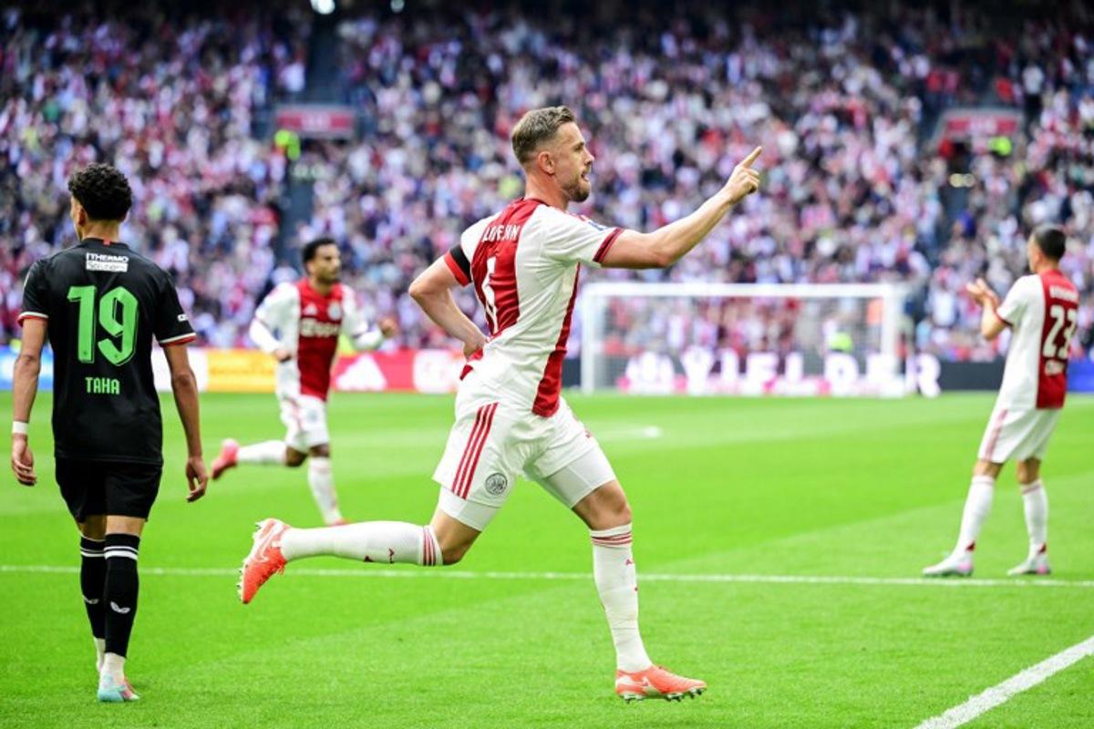Jordan Ajax's English midfielder #6 Jordan Henderson celebrates the team's first goal during the Dutch Eredivisie football match between Ajax Amsterdam and FC Twente at the Johan Cruijff ArenA, in Amsterdam on May 18, 2025. Olaf Kraak / ANP / AFP