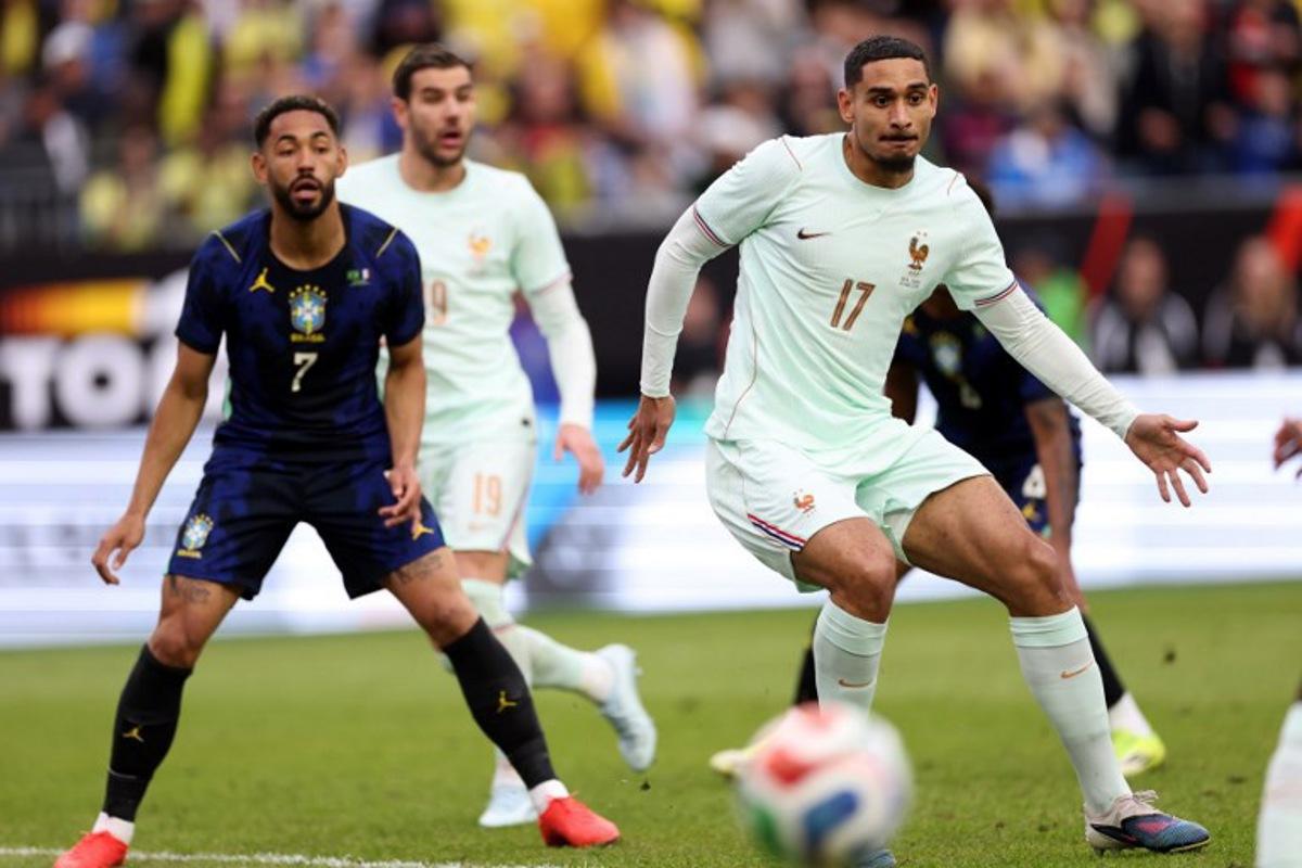 France's defender #17 Maxence Lacroix and Brazil's forward #07 Matheus Cunha look on during a friendly football match between Brazil and France at Gillette Stadium in Foxborough, Massachusetts, on March 26, 2026. FRANCK FIFE / AFP