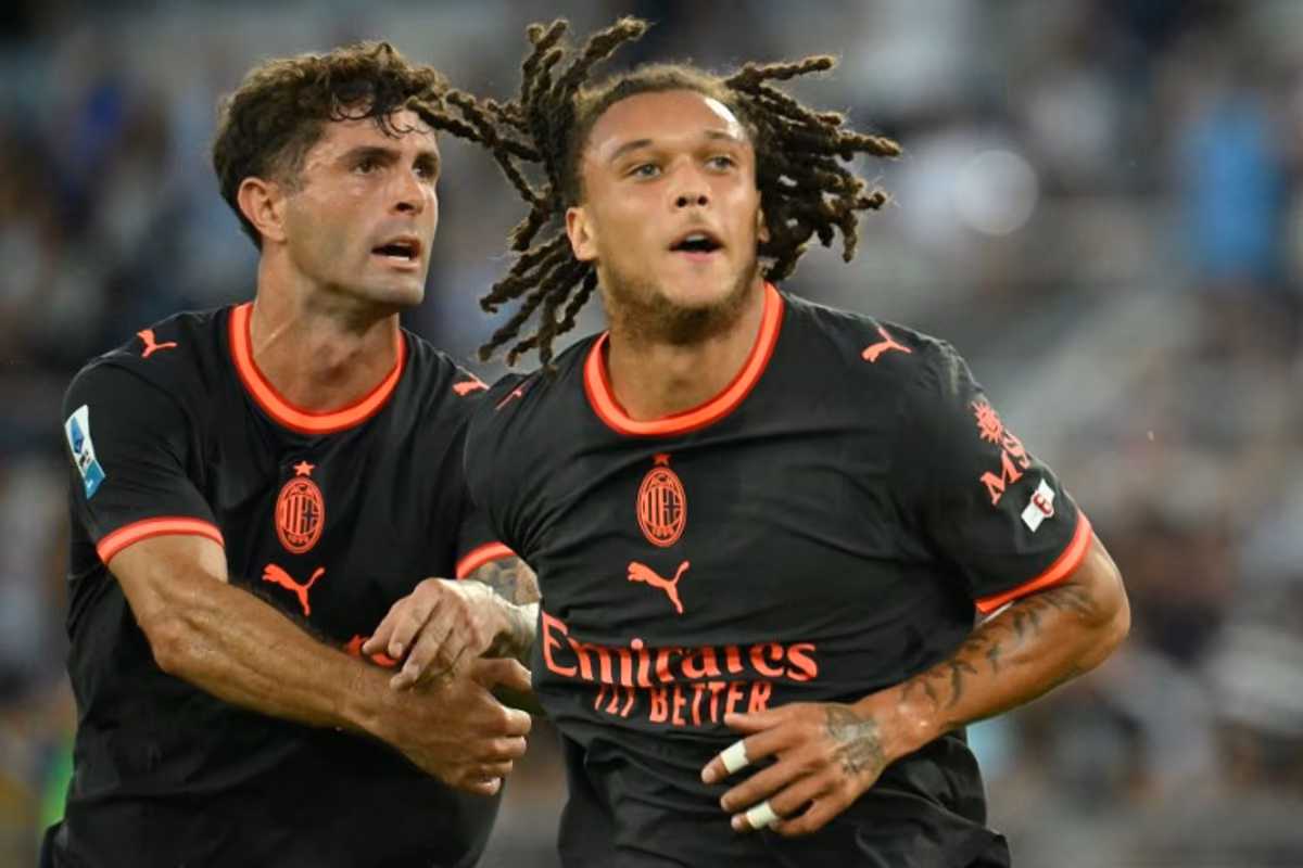 AC Milan's Belgian midfielder #22 Diego Moreira (R) celebrates after scoring Milan's second goal during the Italian Serie A football match between Lazio and AC Milan at the Olympic Stadium in Rome on September 12, 2026. Alberto PIZZOLI / AFP