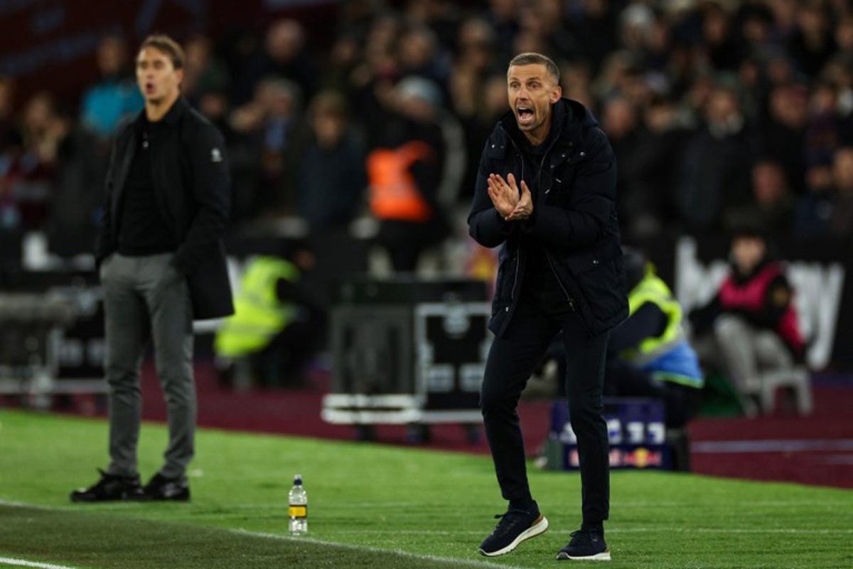 Wolverhampton Wanderers' English head coach Gary O'Neil (R) reacts next to West Ham United's Spanish manager Julen Lopetegui during the English Premier League football match between West Ham United and Wolverhapton Wanderers at the London Stadium, in London on December 9, 2024. Adrian Dennis / AFP