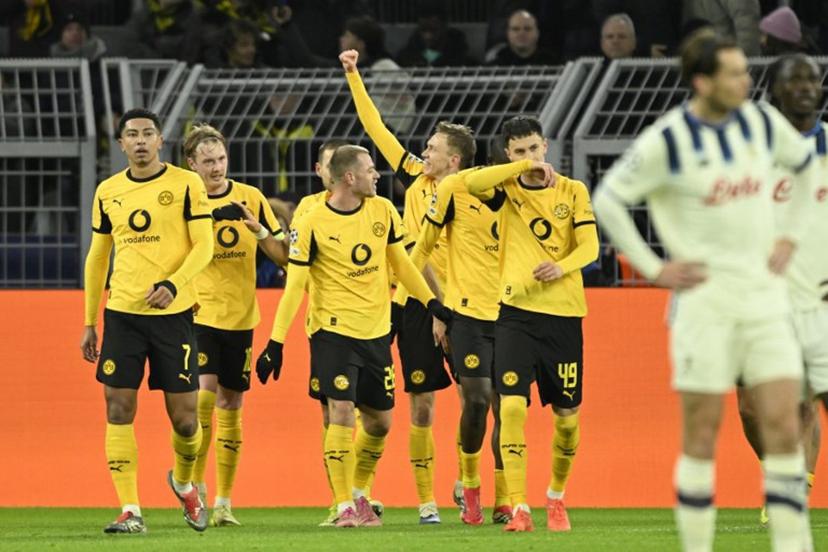 Dortmund's German forward #14 Maximilian Beier celebrates scoring his team's second goal 2:0 with his team mates during the UEFA Champions League knockout round play-off first Leg football match between BVB Borussia Dortmund and Atalanta Bergamo in Dortmund, western Germany, on February 17, 2026. INA FASSBENDER / AFP