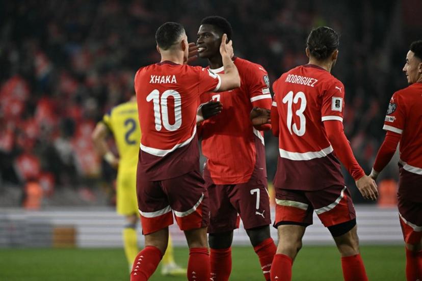 Switzerland's midfielder #10 Granit Xhaka celebrates with Switzerland's forward #07 Breel Embolo after scoring a penalty during the FIFA World Cup 2026 Group B European qualification football match between Switzerland and Sweden at the Geneva stadium, in Geneva, on November 15, 2025. Fabrice COFFRINI / AFP