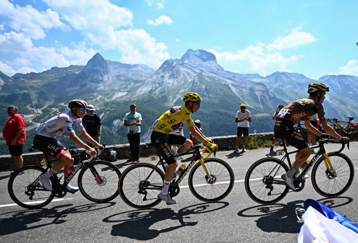 UAE Team Emirates team's Slovenian rider Tadej Pogacar (L) wearing the best young rider's white jersey, Jumbo-Visma team's Danish rider Jonas Vingegaard wearing the overall leader's yellow jersey and Jumbo-Visma team's American rider Sepp Kuss cycle during the 18th stage of the 109th edition of the Tour de France cycling race, 143,2 km between Lourdes and Hautacam in the Pyrenees mountains in southwestern France, on July 21, 2022. Anne-Christine POUJOULAT / AFP