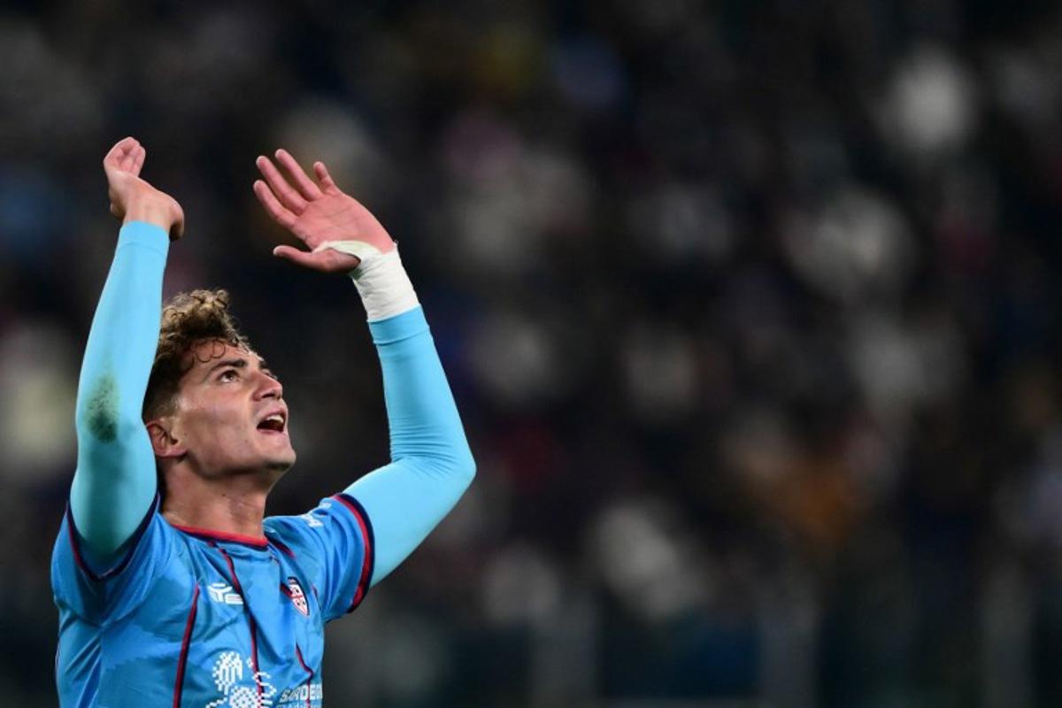 Cagliari's Italian forward #94 Sebastiano Esposito celebrates after scoring his team first goal during the Italian Serie A football match between Juventus and Cagliari at the Allianz Stadium, in Turin, northern Italy, on November 29, 2025. MARCO BERTORELLO / AFP