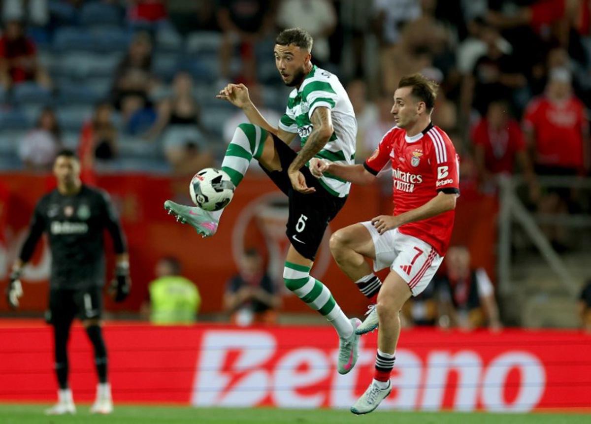 Sporting Lisbon's Belgian defender #06 Zeno Debast is challenged by Benfica's Turkish midfielder #07 Muhammed Akturkoglu during Portugal's Candido de Oliveira Super Cup football final match between Sporting CP and SL Benfica at Algarve Stadium in Loule, southern Portugal, on July 31, 2025. CARLOS COSTA / AFP