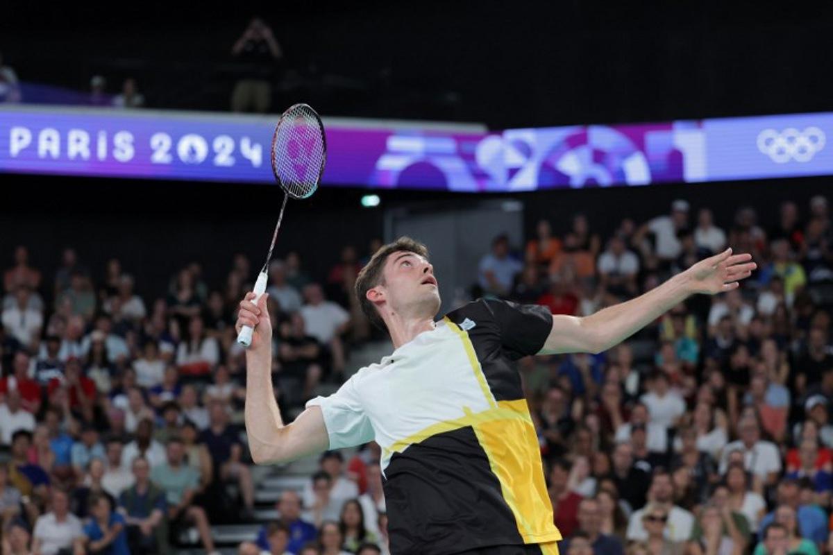 Belgium's Julien Carraggi plays a shot against India's Lakshya Sen in their men's singles badminton group stage match during the Paris 2024 Olympic Games at Porte de la Chapelle Arena in Paris on July 29, 2024. David GRAY / AFP