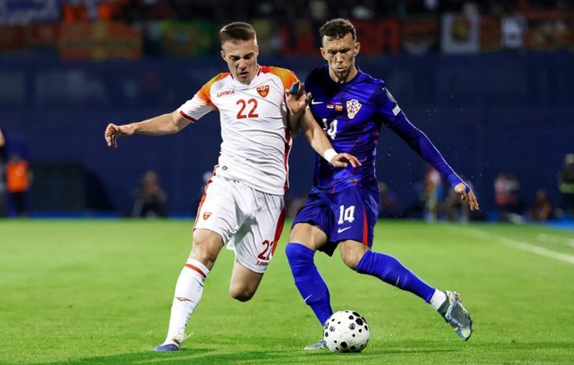 Croatia's forward #14 Ivan Perisic (R) fights for the ball with Montenegro's midfielder #22 Milan Roganovic #22 (L) during the FIFA World Cup 2026 Group L qualification football match between Croatia and Montenegro at the Maksimir Stadium in Zagreb, on September 8, 2025. DAMIR SENCAR / AFP