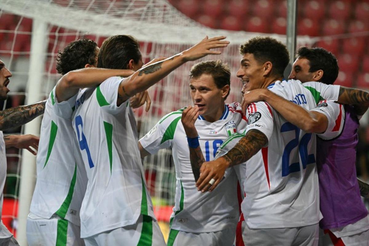 Italy's players celebrate after scoring the 2-3 goal during the 2026 World Cup qualifiers Europe zone group I football match between Israel and Italy on September 8, 2025 in Debrecen, Hungary. Attila KISBENEDEK / AFP
