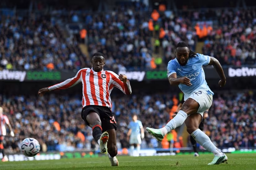 Manchester City's Ghanaian midfielder #42 Antoine Semenyo (R) shoots to score their fourth goal during the English Premier League football match between Manchester City and Sunderland at the Etihad Stadium in Manchester, north west England, on September 20, 2026. PETER POWELL / AFP