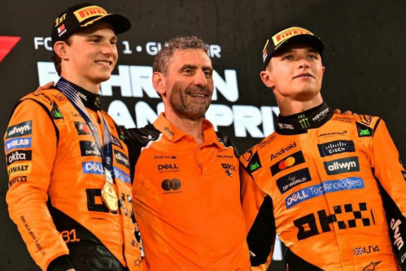 McLaren's Australian driver Oscar Piastri and McLaren's British driver Lando Norris stand on the podium with McLaren team principal Andrea Stella after the Bahrain Formula One Grand Prix at the Bahrain International Circuit in Sakhir on April 13, 2025. Giuseppe CACACE / AFP
