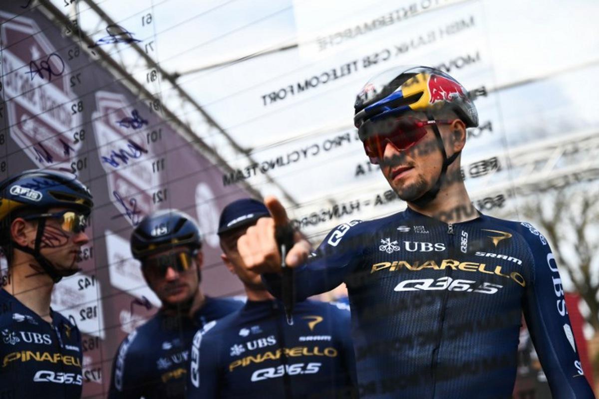 Pinarello-Q36.5 Pro Cycling Team's British Thomas Pidcock signs ahead of the 20th one-day classic 'Strade Bianche' (White Roads) men's cycling race between Siena and Siena in Tuscany on March 7, 2026. Marco BERTORELLO / AFP
