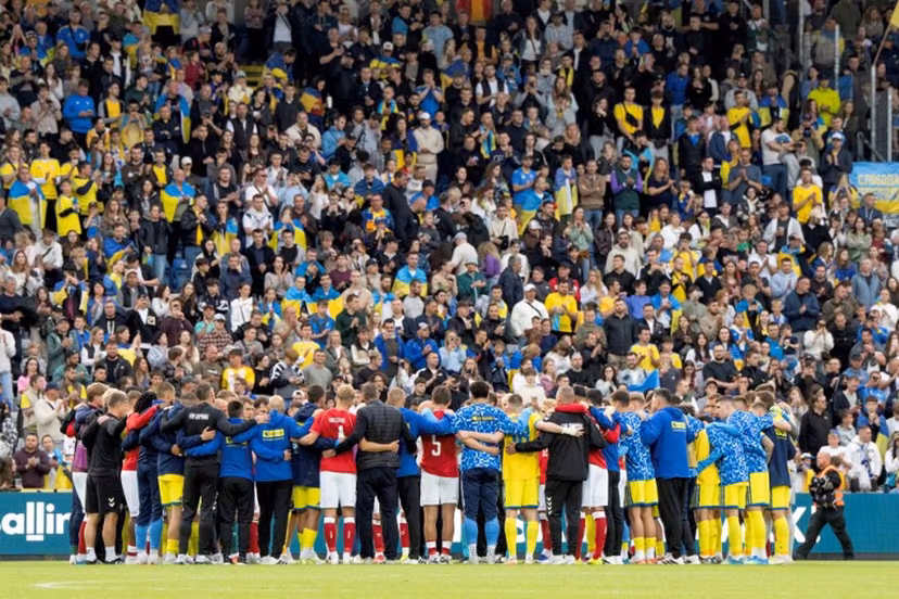 Denmark's and Ukraine's players huddle on the pitch during the football international friendly match between Denmark and Ukraine at Odense Stadium in Denmark, on June 7, 2026. Christian Eriksen collapsed during Denmark's friendly against Ukraine on June 7, 2026, five years after he suffered a cardiac arrest during the European Championships. Bo Amstrup / AFP
