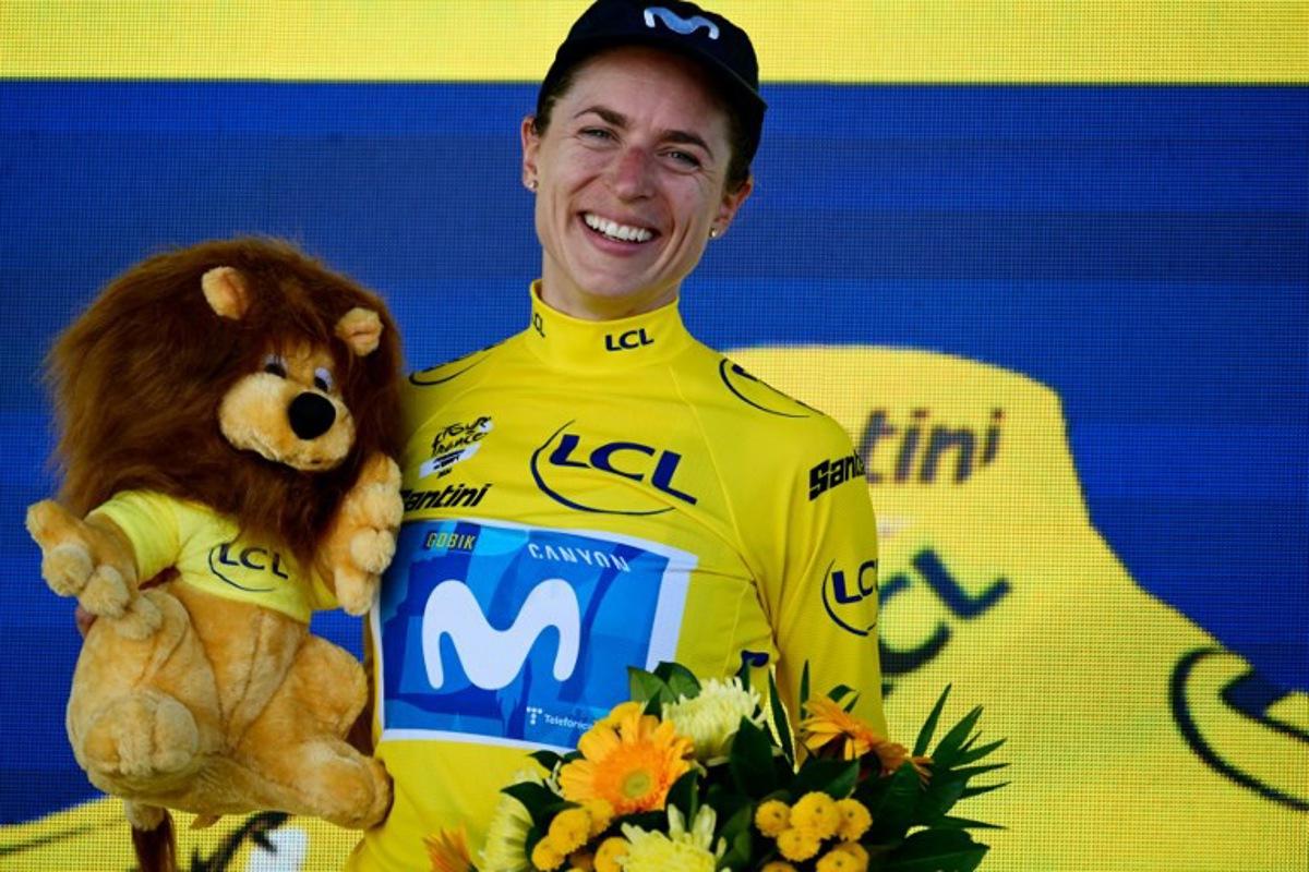 Movistar Team's Swiss rider Marlen Reusser poses on the podium with the overall leader's yellow jersey after placing second of the 5th (out of 9) stage of the fifth edition of the Women's Tour de France cycling race, 140 km from Macon to Belleville-en-Beaujolais, in Belleville-en-Beaujolais, central France on August 5, 2026. NICOLAS TUCAT / AFP