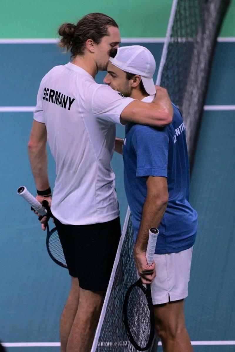 Germany's Alexander Zverev (L) and Argentina's Francisco Cerundolo embrace at the end of their match during the Davis Cup men's singles quarter finals tennis match, at the Super Tennis Arena, in Bologna, northen Italy, on November 20, 2025. Tiziana FABI / AFP