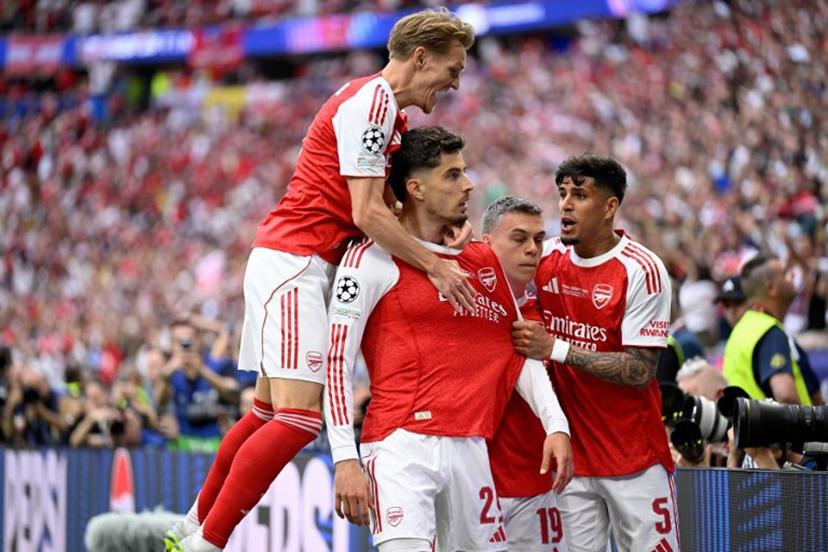 Arsenal's German forward #29 Kai Havertz (2L) celebrates after scoring the opening goal with Arsenal's Norwegian midfielder #08 Martin Odegaard (L) and teammates during the UEFA Champions League final football match between Paris Saint-Germain (PSG) and Arsenal FC at the Puskas Arena in Budapest on May 30, 2026. INA FASSBENDER / AFP