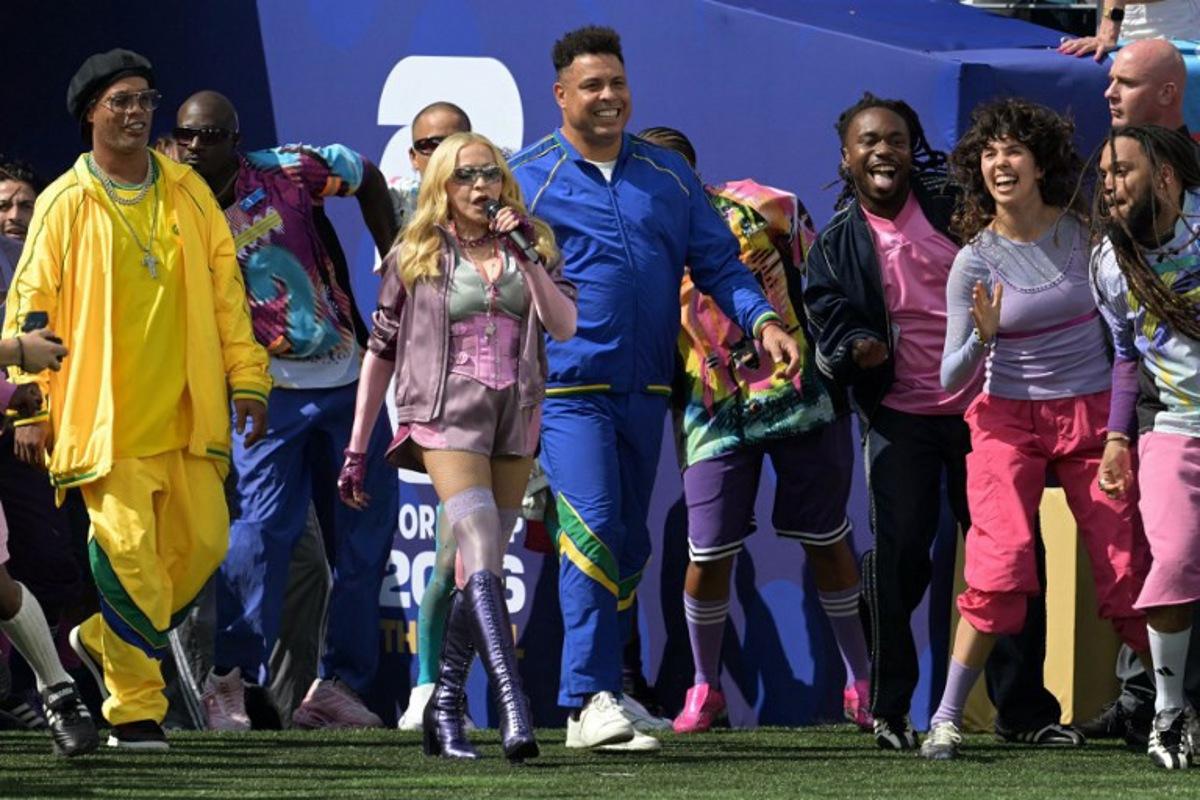 US singer Madonna (C) performs with Brazilian footballer Ronaldinho (L) and Brazilian former footballer Ronaldo during the halftime show of the 2026 World Cup football tournament final match between Spain and Argentina at the New York/New Jersey Stadium in East Rutherford on July 19, 2026. JUAN MABROMATA / AFP