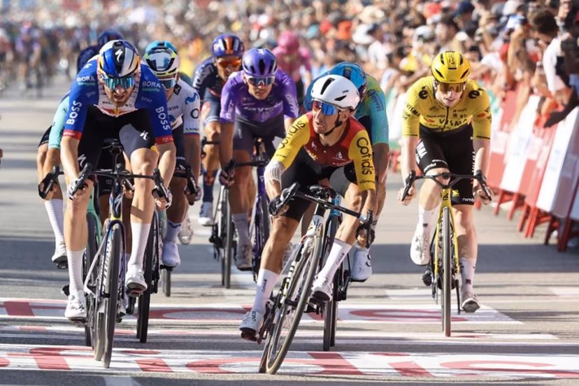 Team Cofidis' French rider Bryan Coquard (C) crosses the finish line to win the eighth stage of the Vuelta a Espana 2026, a 171 km race between Pucol and Xeraco on August 29, 2026. Josep LAGO / AFP