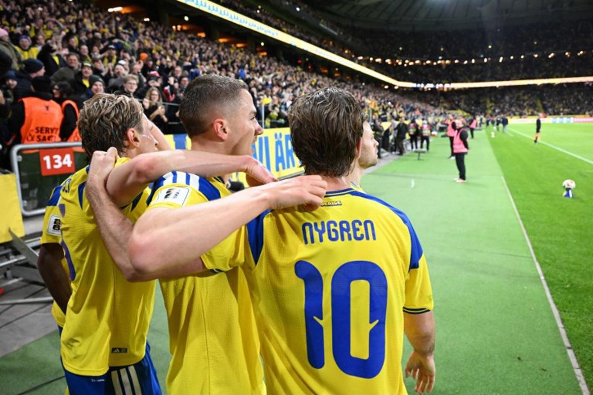 Sweden's defender #02 Gustaf Lagerbielke celebrates scoring his team's second goal 2:1 with his team mates during the FIFA World Cup 2026 European qualification final football match between Sweden and Poland in Solna, Sweden, on March 31, 2026. Jonathan Nackstrand / AFP