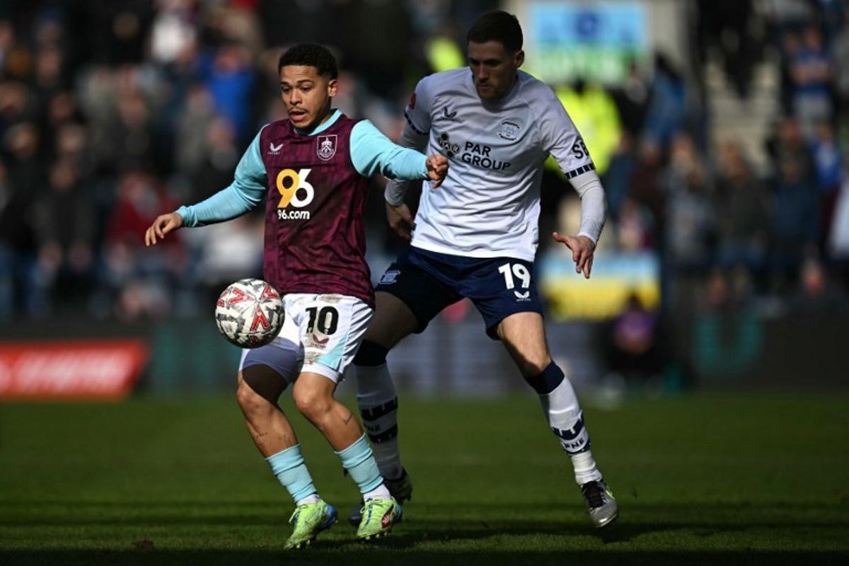Burnley's Belgian midfielder #10 Manuel Benson battles for the ball with Preston's English defender #19 Lewis Gibson during the English FA Cup fifth round football match between Preston North End and Burnley at Deepdale stadium in Preston, north-west England on March 1, 2025. Paul ELLIS / AFP