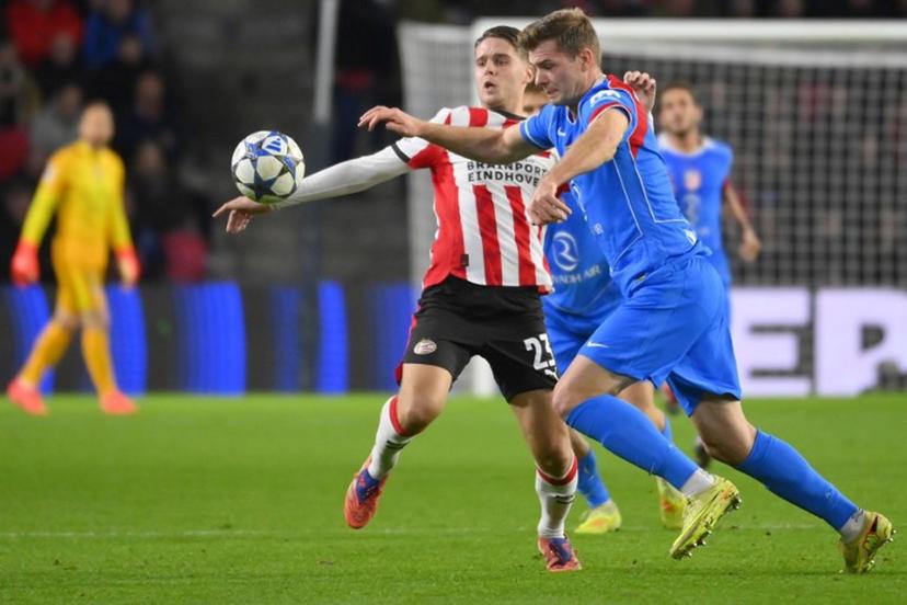 PSV Eindhoven's Dutch midfielder #23 Joey Veerman (L) fights for the ball with Atletico Madrid's Norwegian forward #09 Alexander Sorloth during the UEFA Champions League, league phase day 6, football match between PSV Eindhoven (NED) and Atletico Madrid (ESP), at the Philips Stadion, in Eindhoven, south of The Netherlands, on December 9, 2025. JOHN THYS / AFP