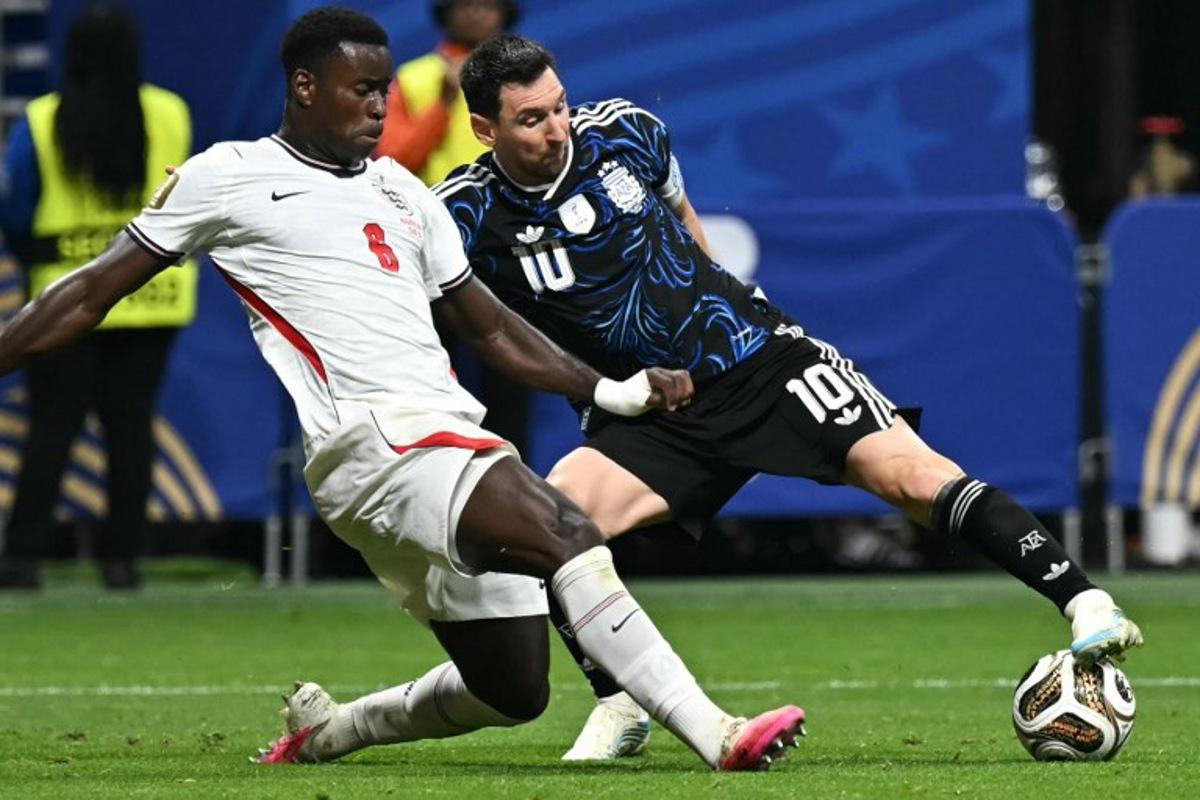 England's defender #06 Marc Guehi (L) and Argentina's forward #10 Lionel Messi fight for the ball during the 2026 World Cup football tournament semi-final match between England and Argentina at the Atlanta Stadium in Atlanta on July 15, 2026. Paul ELLIS / AFP