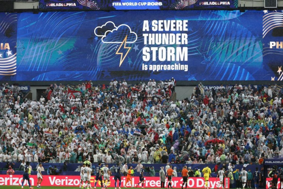 A screen shows a severe thunder storm warning during the 2026 World Cup Group I football match between France and Iraq at the Philadelphia Stadium in Philadelphia on June 22, 2026. FRANCK FIFE / AFP