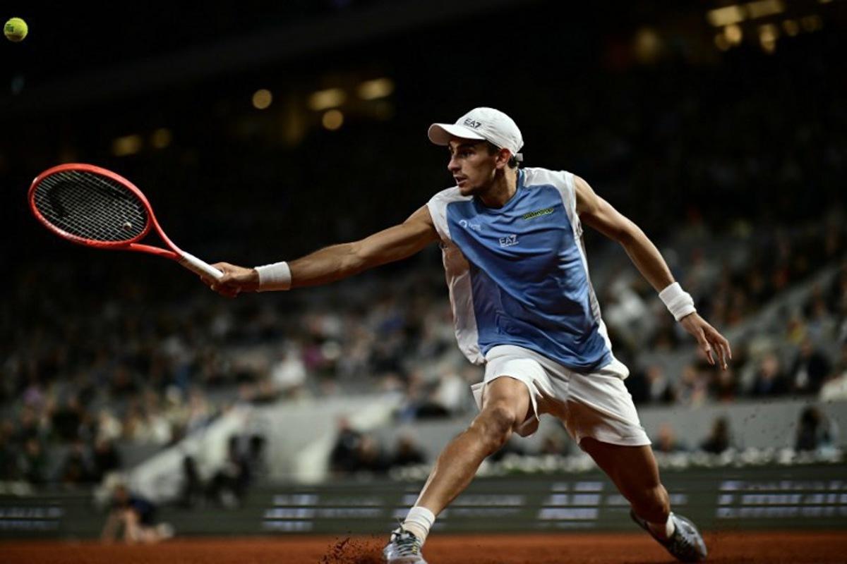 Italy's Matteo Arnaldi plays a backhand return to Italy's Matteo Berrettini during their men's quarter final singles match on day 11 of the French Open tennis tournament on Court Philippe-Chatrier at the Roland-Garros Complex in Paris on June 3, 2026. JULIEN DE ROSA / AFP