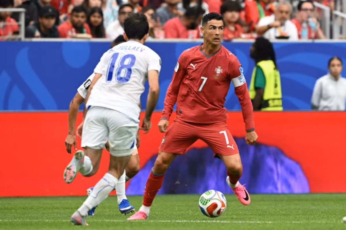 Portugal's forward #07 Cristiano Ronaldo (R) runs with the ball during the 2026 World Cup Group K football match between Portugal and Uzbekistan at the Houston Stadium in Houston on June 23, 2026. RONALDO SCHEMIDT / AFP