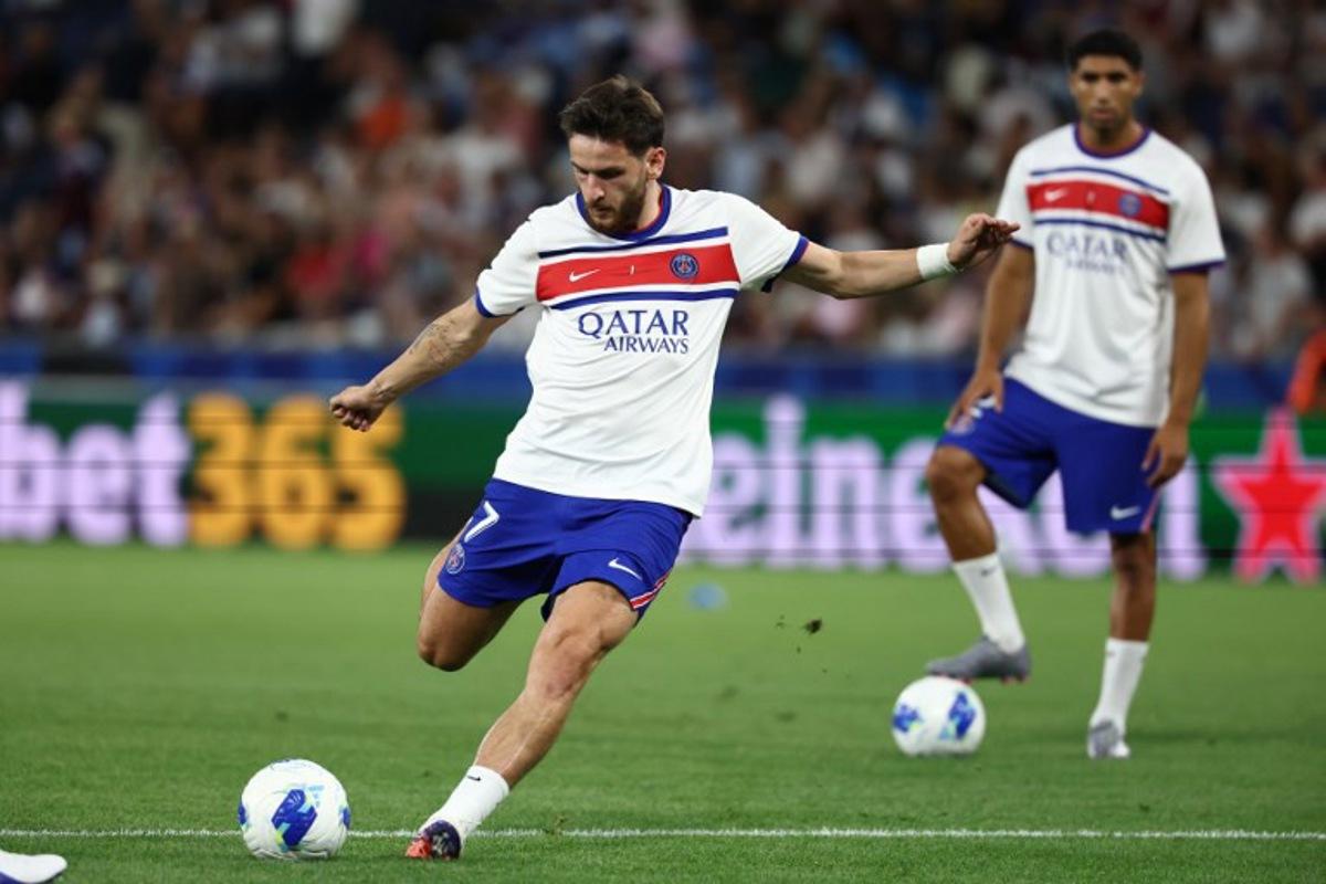 Paris Saint-Germain's Georgian forward #07 Khvicha Kvaratskhelia shoots during the warm up prior to the UEFA Supercup football match between Champions League winners Paris Saint Germain (PSG) and Europa League winners Aston Villa in Salzburg, Austria on August 12, 2026. FRANCK FIFE / AFP