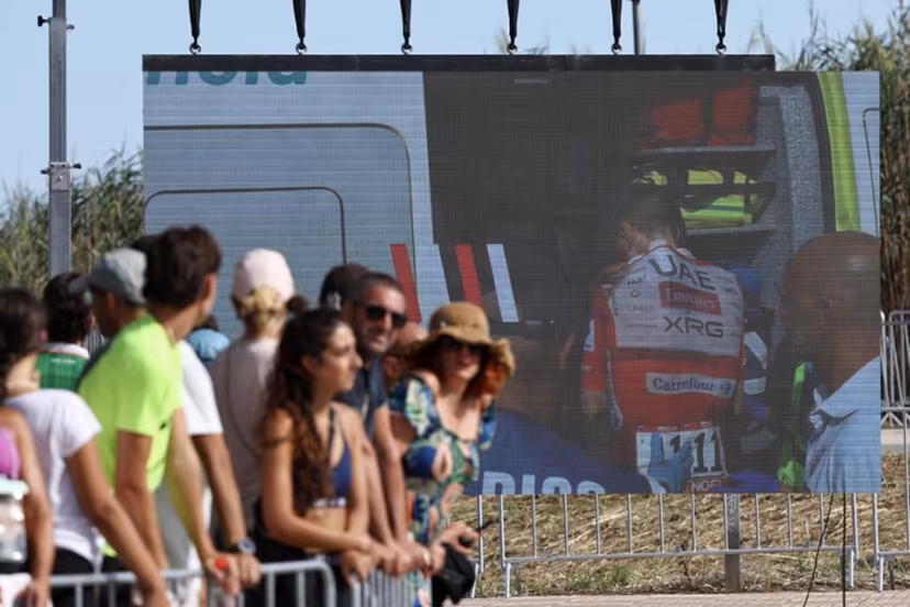 Team UAE's Slovenian rider Tadej Pogacar is seen entering an ambulance after crashing on a giant screen in the finish area of the Vuelta a Espana 2026, a 171 km race between Pucol and Xeraco on August 29, 2026. Race leader Tadej Pogacar pulled out of the Vuelta a Espana on Saturday after a heavy fall 31km from the finish of a flat stage eight left him with shoulder and face injuries. Pogacar of Team UAE has won five Tour de France titles and a Giro d'Italia and was targeting his first overall victory on the Spanish 21-day race. Josep LAGO / AFP