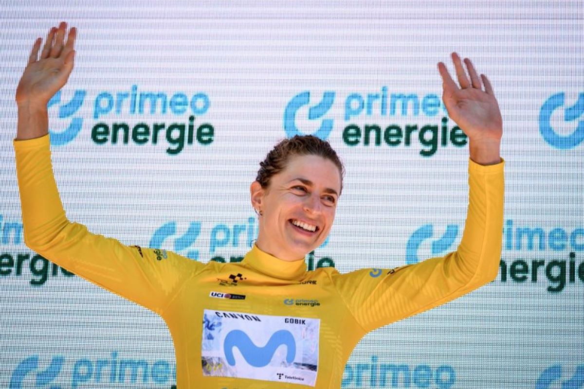Switzerland's Marlen Reusser wearing the overall leader's yellow jersey celebrates on the podium after winning in the fourth stage, a 23,7 km time trial from Aarburg to Aarburg, at the Women's Tour of Switzerland (Tour de Suisse) cycling race in Aarburg, Switzerland, on June 20, 2026. Fabrice COFFRINI / AFP