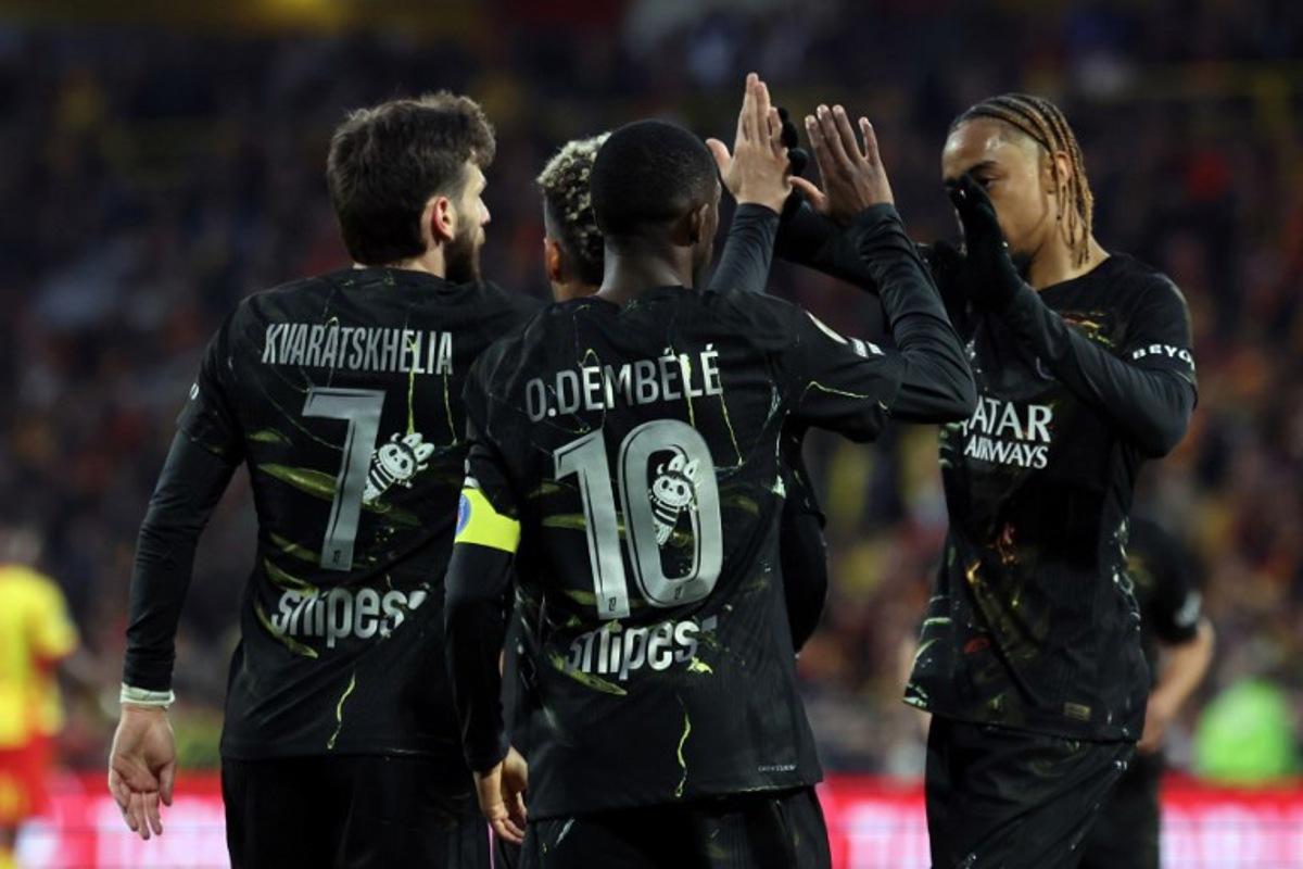 Paris Saint-Germain's Georgian forward #07 Khvicha Kvaratskhelia (L) is congratulated by Paris Saint-Germain's French forward #10 Ousmane Dembele (C) and Paris Saint-Germain's French forward #29 Bradley Barcola after scoring a goal during the French L1 football match between RC Lens and Paris Saint-Germain (PSG) at the Stade Bollaert-Delelis stadium in Lens on May 13, 2026. Francois LO PRESTI / AFP