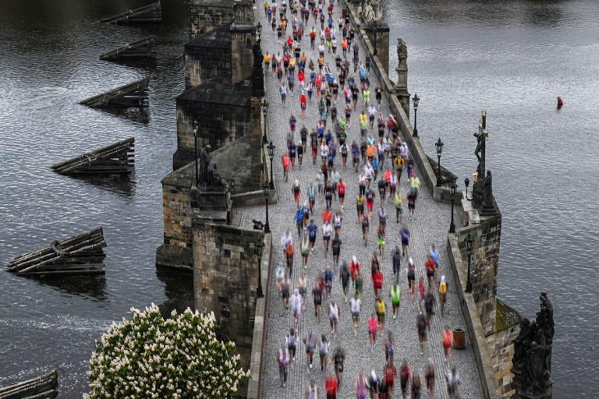 Participants run across the Charles Bridge as they take part in the Prague's international marathon on May 4, 2025 in Prague, Czech Republic. Michal Cizek / AFP