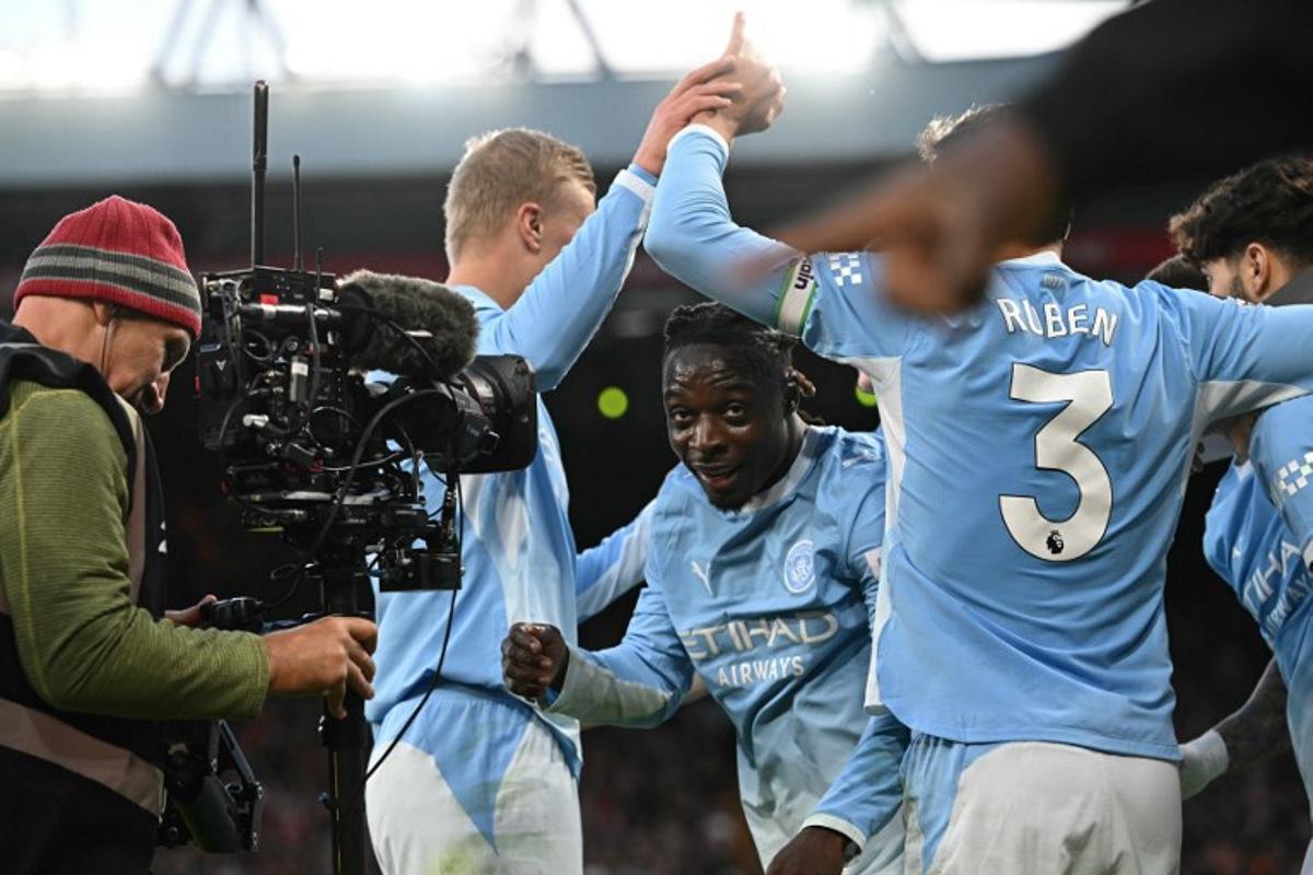 Manchester City's Belgian midfielder #11 Jeremy Doku (C) celebrates with teammates after scoring their second goal during the English Premier League football match between Liverpool and Manchester City at Anfield in Liverpool, north west England on October 11, 2026. Paul ELLIS / AFP
