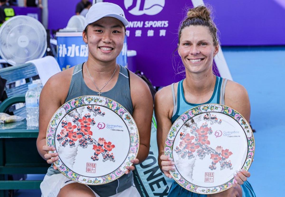 Winners Indonesia's Janice Tjen (L) and Poland's Katarzyna Piter pose with their women's doubles trophies after winning against Hong Kong's Eudice Chong and Taiwan's Liang En-shuo during an award ceremony at the Guangzhou Open tennis tournament in Guangzhou, southern China's Guangdong province on October 26, 2025. STR / AFP