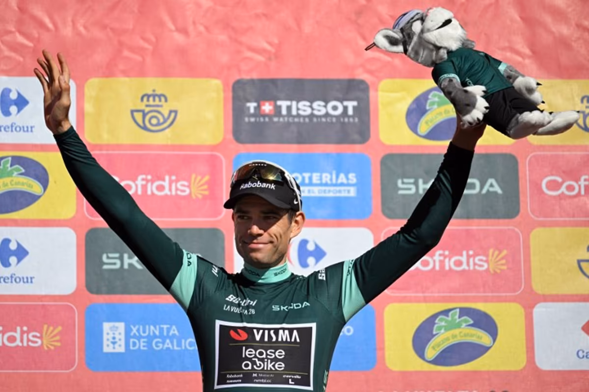 Team Visma-Lease a bike's Belgian rider Wout van Aert celebrates on the podium retaining the points leader's green jersey after the 20th stage of the Vuelta a Espana 2026 cycling tour, a 186,8 km race between La Calahorra and Collado del Alguacil, on September 12, 2026. JORGE GUERRERO / AFP