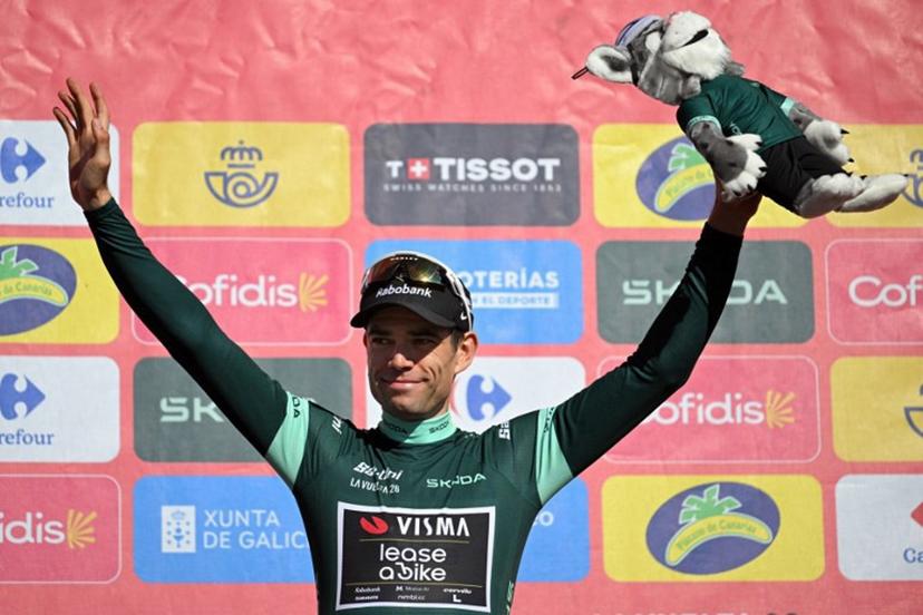Team Visma-Lease a bike's Belgian rider Wout van Aert celebrates on the podium retaining the points leader's green jersey after the 20th stage of the Vuelta a Espana 2026 cycling tour, a 186,8 km race between La Calahorra and Collado del Alguacil, on September 12, 2026. JORGE GUERRERO / AFP