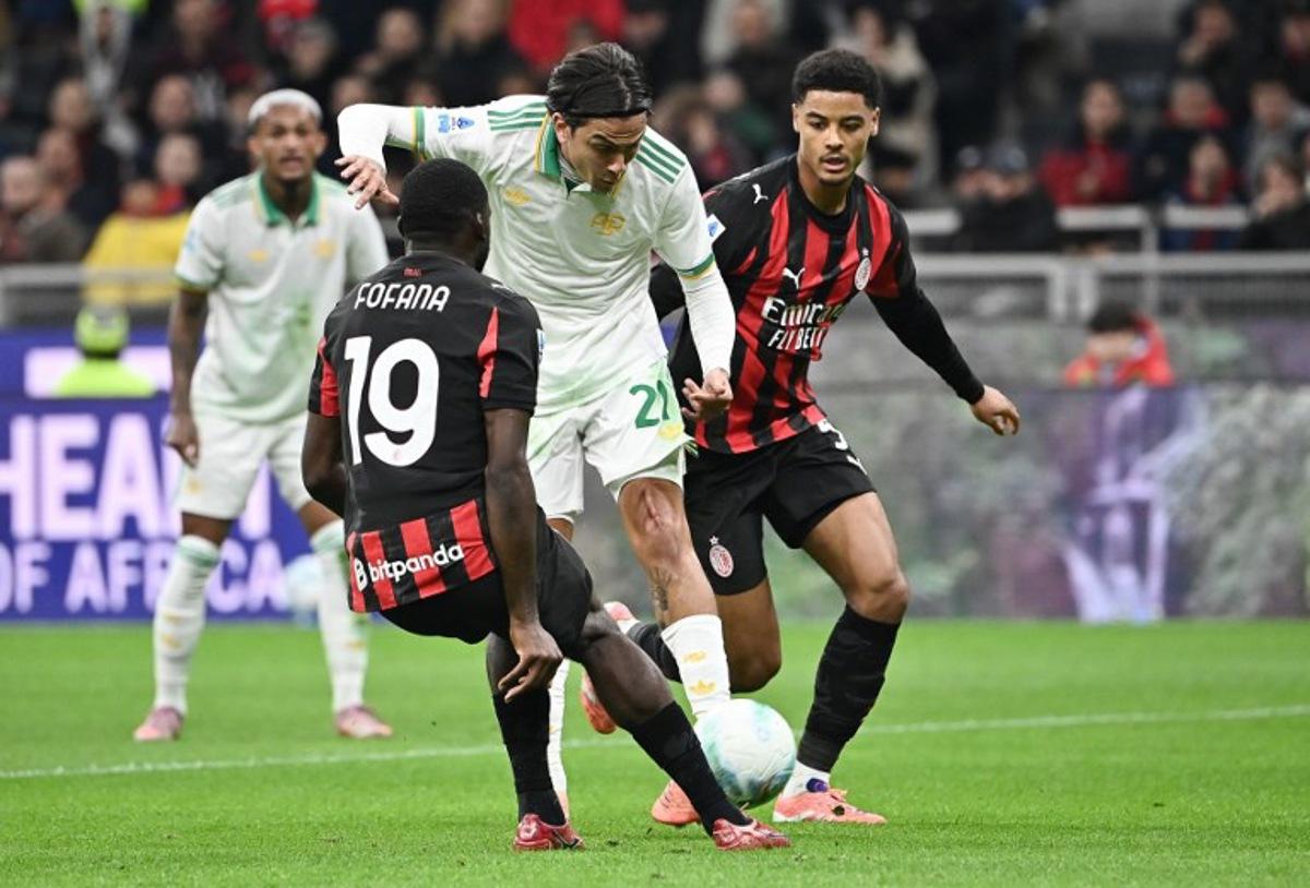 Roma's Argentine forward #21 Paulo Dybala (C) fights for the ball with AC Milan's French midfielder #19 Youssouf Fofana (L) and AC Milan's Belgian defender #05 Koni De Winter (R) during the Italian Serie A football match between AC Milan and AS Roma at San Siro stadium in Milan, on November 2, 2025.  Isabella BONOTTO / AFP
