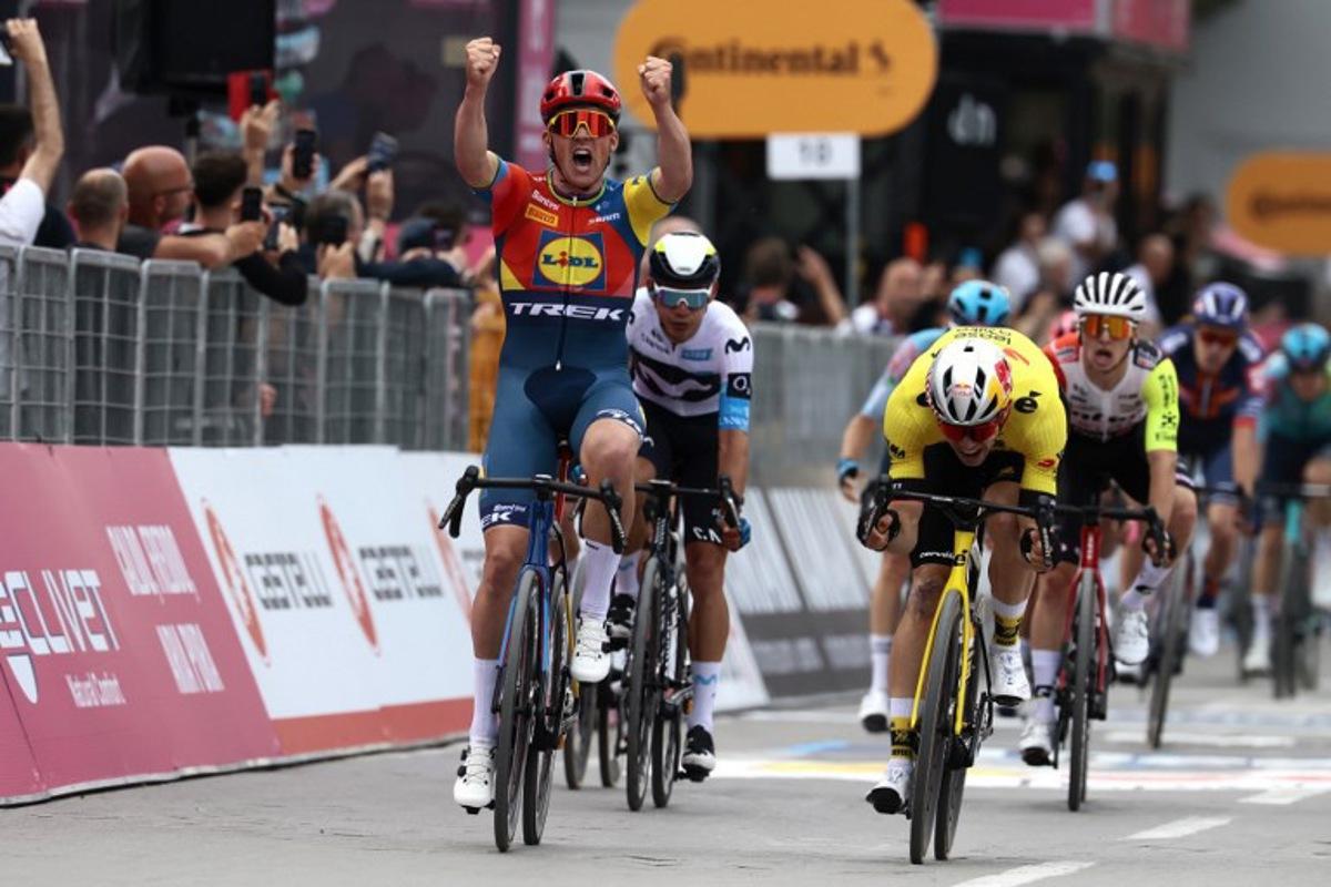Lidl-Trek's Danish rider Mads Pedersen, next to Team Visma-Lease a Bike's Belgian rider Wout Van Aert (R), celebrates as he crosses the finish to win the first stage of the 108th Giro d'Italia cycling race, 160km from Durres to Tirana in Albania, on May 9, 2025. Luca Bettini / AFP