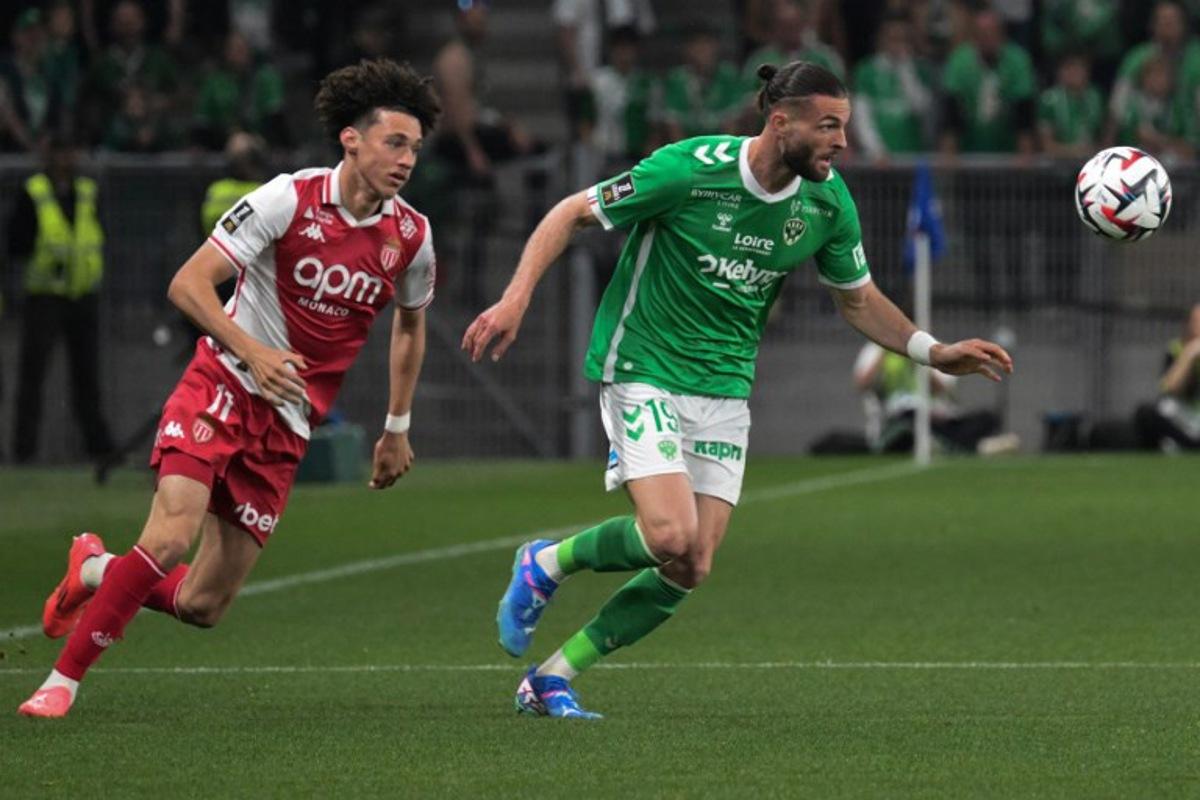 Monaco's French midfielder #11 Maghnes Akliouche (L) fights the ball with Saint Etienne's French defender #19 Leo Petrot (R) during the French L1 football match between AS Saint-Etienne and AS Monaco at the Geoffroy Guichard Stadium in Saint-Etienne, central-eastern France, on May 3, 2025. JEAN-PHILIPPE KSIAZEK / AFP