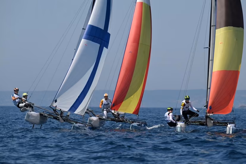 (LtoR) Finland's duo Sinem Kurtbay and Akseli Keskinen, Spain's duo Tara Pacheco van Rijnsoever and Andres Barrio Garcia and Belgium's duo Lucas Claeyssens and Eline Verstraelen compete in race 11 of the mixed Nacra 17 multihull event during the Paris 2024 Olympic Games sailing competition at the Roucas-Blanc Marina in Marseille on August 6, 2024. NICOLAS TUCAT / AFP