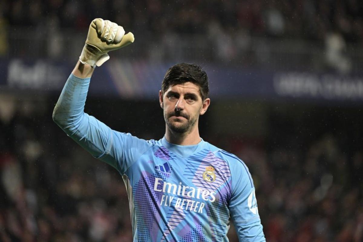 Real Madrid's Belgian goalkeeper #01 Thibaut Courtois gestures to supporters after Real Madrid won the UEFA Champions League, league phase - matchday 8 between Stade Brestois 29 (Brest) and Real Madrid CF at the Roudourou Stadium in Guingamp, north-western France, on January 29, 2025. Damien MEYER / AFP