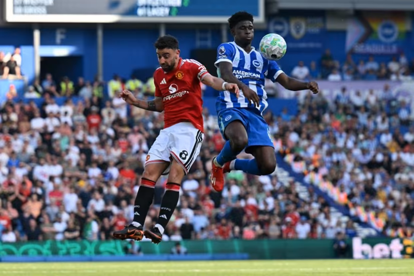 Manchester United's Portuguese midfielder #08 Bruno Fernandes (L) vies with Brighton's Cameroonian midfielder #17 Carlos Baleba during the English Premier League football match between Brighton and Hove Albion and Manchester United at the American Express Community Stadium in Brighton, southern England on May 24, 2026. Glyn KIRK / AFP