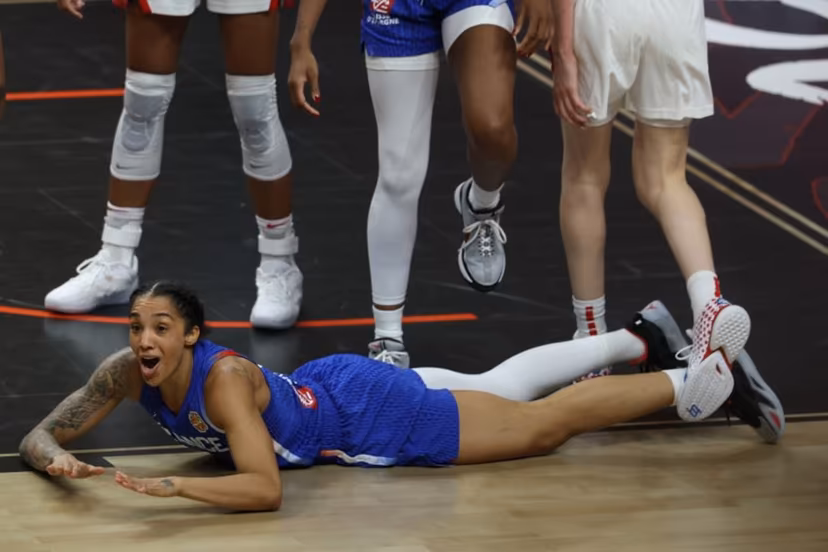 France's forward #15 Gabby Williams reacts as she lays on the pitch during the 2026 FIBA Women's Basketball World Cup final game between the United States and France in Berlin on September 13, 2026. Odd ANDERSEN / AFP